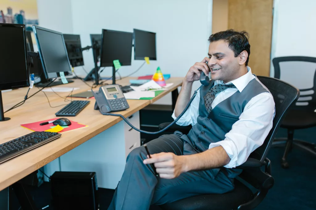 A selling a company offer to a client over the phone. 