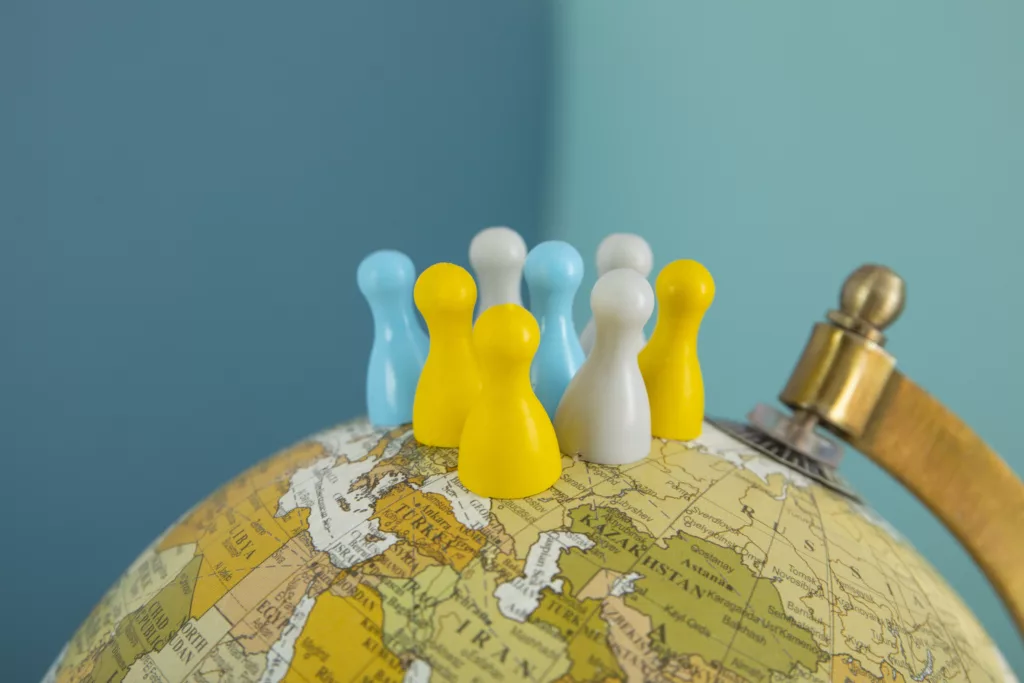 Pawns stacked on a globe.