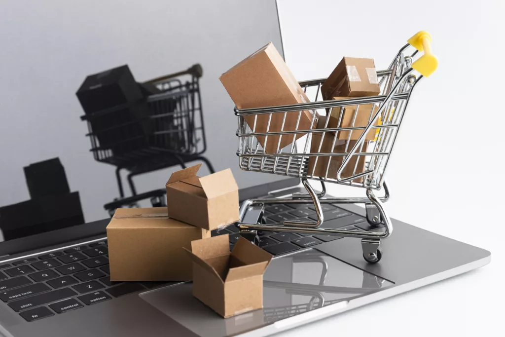 a laptop with boxes unpacked and a shopping cart